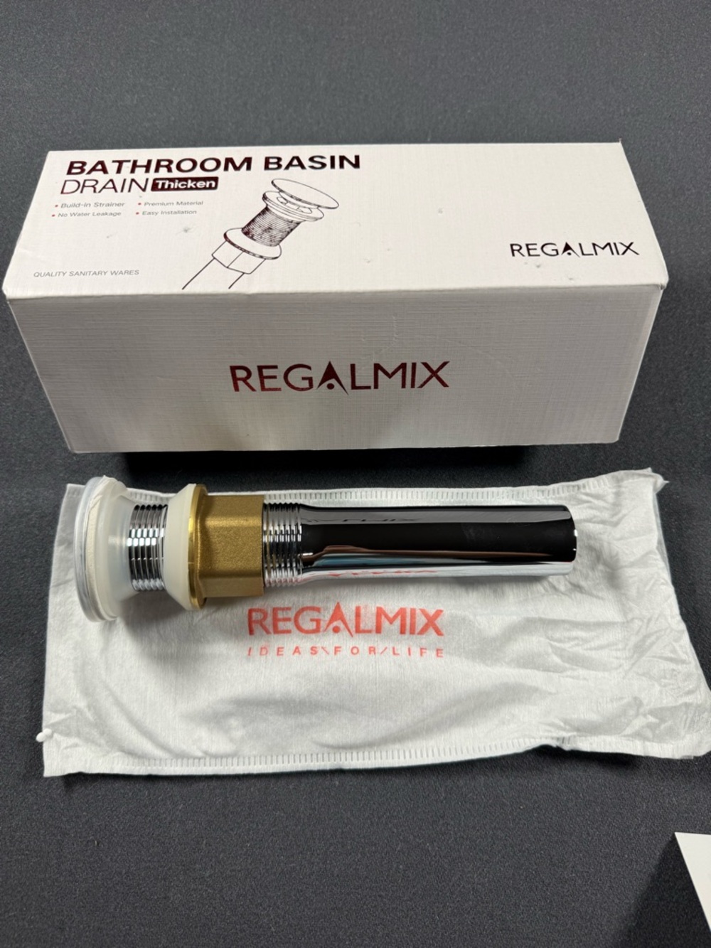 Regalmix bathroom basin drain featuring a pop-up stopper and a built-in strainer